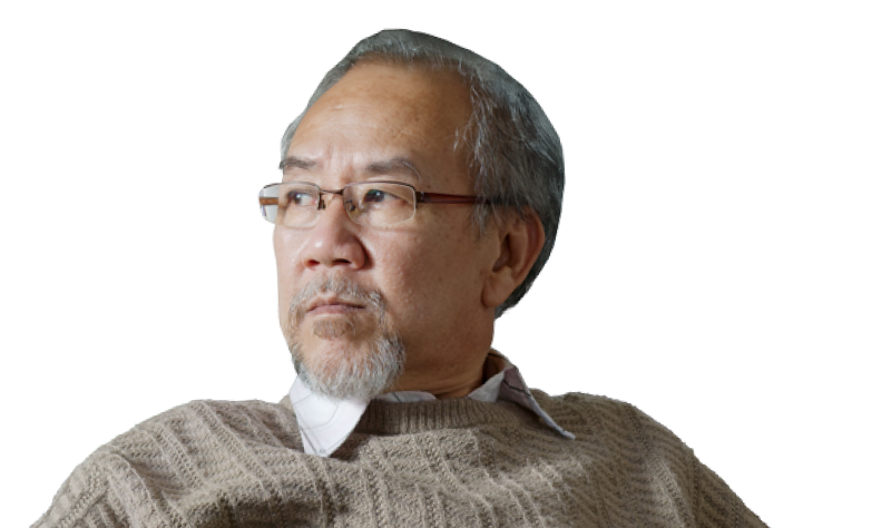 A man with glasses looking to the side